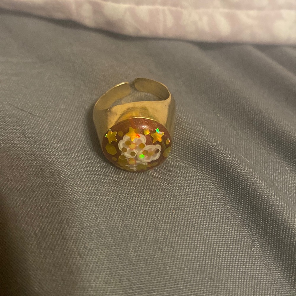 gold ring with red decorated with stars